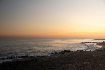 a beach and the sea at sunset in Marbella