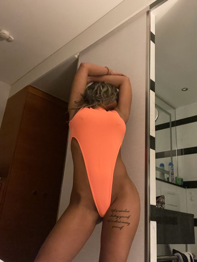 Aida wearing a orange bikini