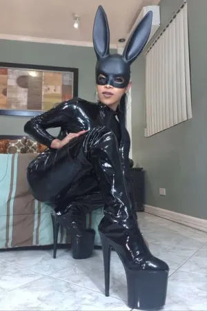 Agatha Shemale wearing huge high heels and black rabbit ears and black PVC latex dress