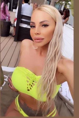 Anyas taking a selfie in a green bikini top