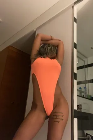 Aida wearing a orange bikini