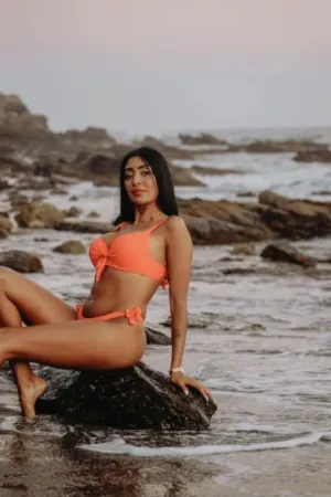 Maya looking sexy on the beach wearing an orange bikini