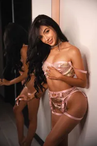 Alberta standing in front of the mirror while showing off her newest set of lingerie 